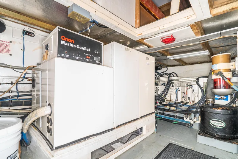 Slide: The Image of Engine room of a 1996 Hatteras 70 Sport Deck Motor Yacht with Onan Marine GenSet. - 11