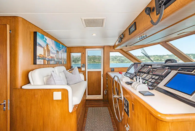 Slide: The Image of Interior of 1996 Hatteras 70 Sport Deck Motor Yacht helm station with seating and navigation equipment. - 12