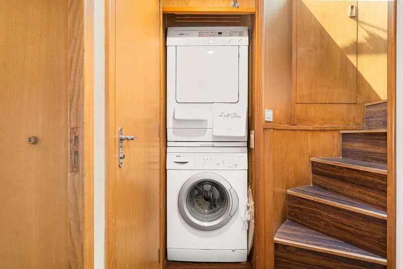 Slide: The Image of Stacked washer and dryer in 1996 Hatteras 70 Sport Deck Motor Yacht laundry area. - 16