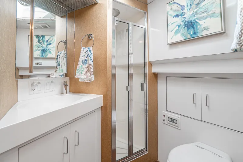Slide: The Image of Modern bathroom on 1996 Hatteras 70 Sport Deck Motor Yacht with shower and white cabinetry. - 18