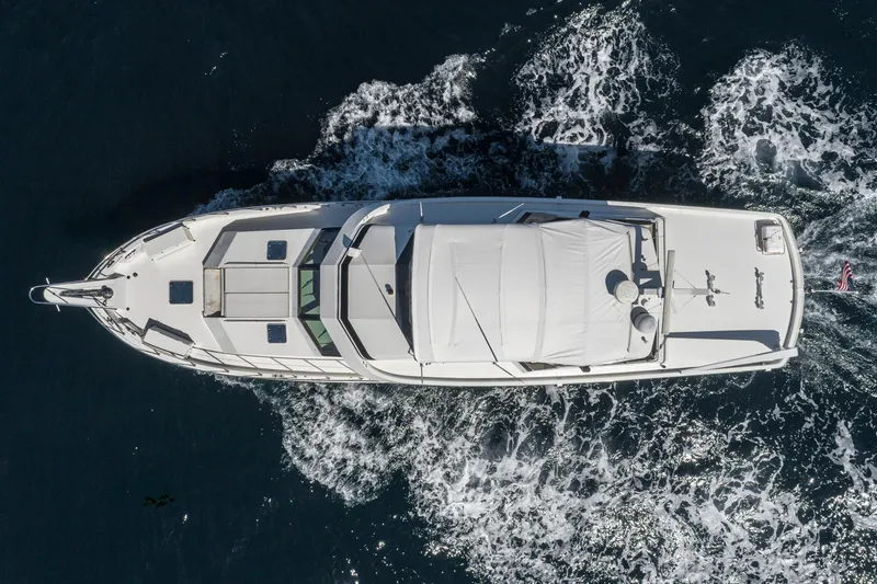 Slide: The Image of Aerial view of 1996 Hatteras 70 Sport Deck Motor Yacht cruising on water. - 2