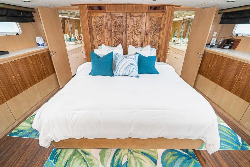 Slide: The Image of Luxurious bedroom in a 1996 Hatteras 70 Sport Deck Motor Yacht with elegant decor. - 23