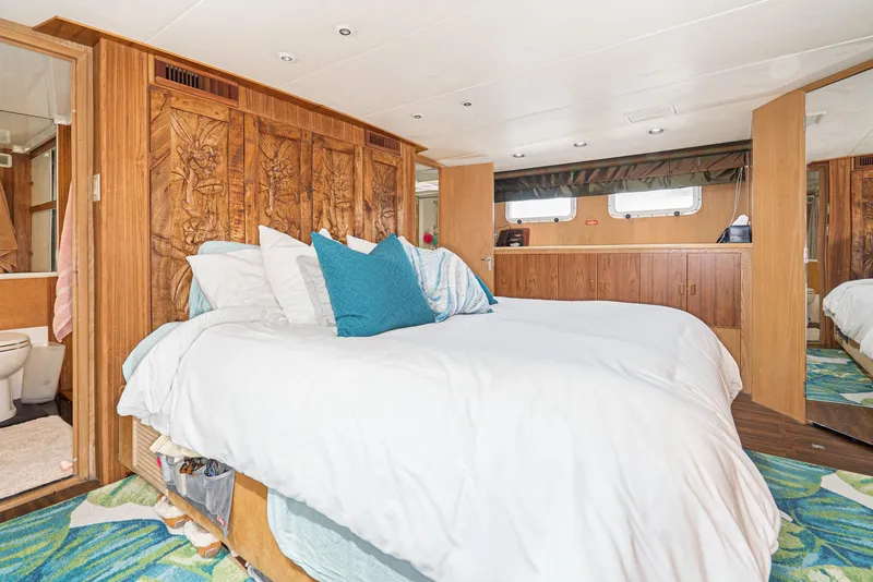 Slide: The Image of Luxurious bedroom in a 1996 Hatteras 70 Sport Deck Motor Yacht with ensuite bathroom. - 24