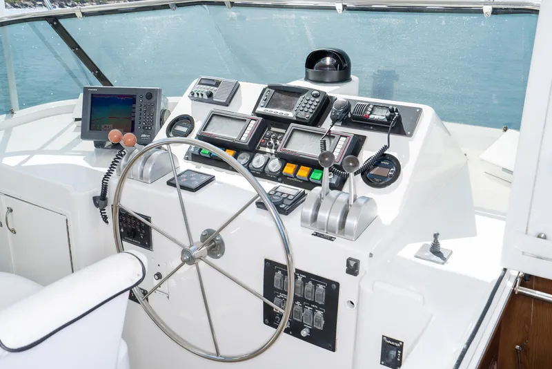Slide: The Image of Helm station of 1996 Hatteras 70 Sport Deck Motor Yacht with navigation and control instruments. - 40