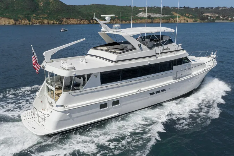 Slide: The Image of 1996 Hatteras 70 Sport Deck Motor Yacht cruising on the water. - 43