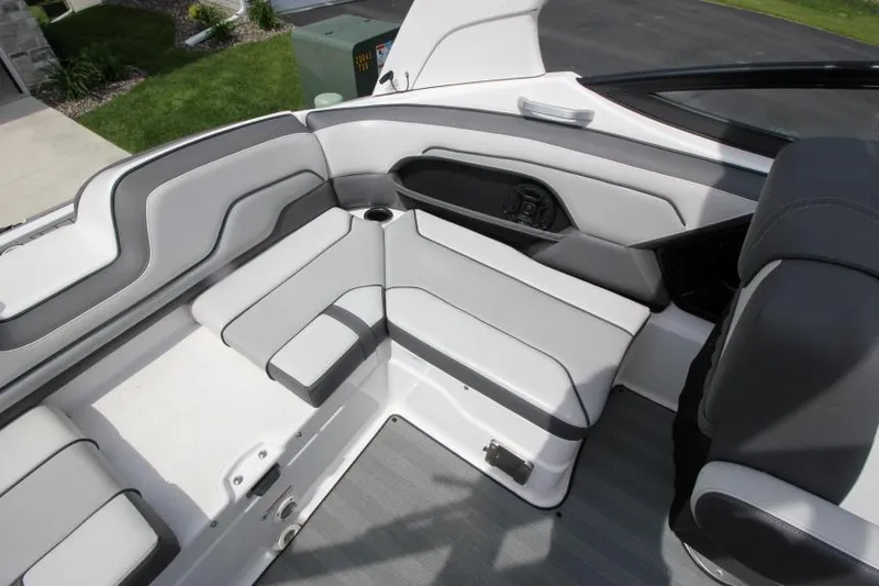 Slide: The Image of 2019 Yamaha Boats 212 Limited S interior seating area with gray and white upholstery. - 11