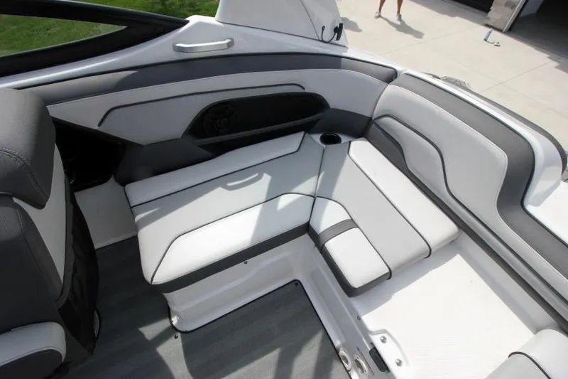 Slide: The Image of 2019 Yamaha Boats 212 Limited S interior seating area with gray and white upholstery. - 12