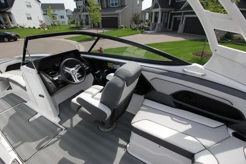 Slide: The Image of 2019 Yamaha Boats 212 Limited S interior cockpit with steering wheel and seating. - 14