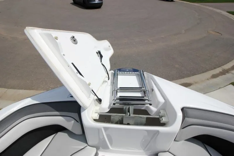Slide: The Image of 2019 Yamaha Boats 212 Limited S bow storage compartment with ladder. - 24