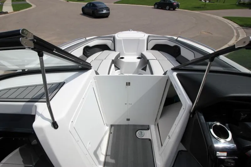 Slide: The Image of 2019 Yamaha Boats 212 Limited S interior view with open storage compartment. - 29