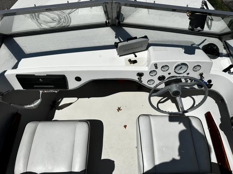 Slide: The Image of 1967 Bertram 20 Moppie boat cockpit with Garmin navigation system and dual seats. - 6