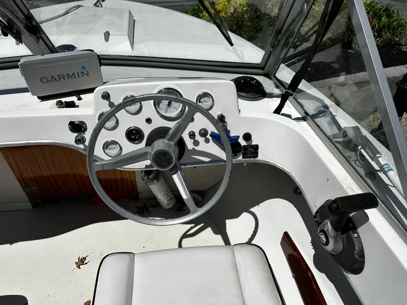 Slide: The Image of 1967 Bertram 20 Moppie boat cockpit with Garmin navigation system and steering wheel. - 7