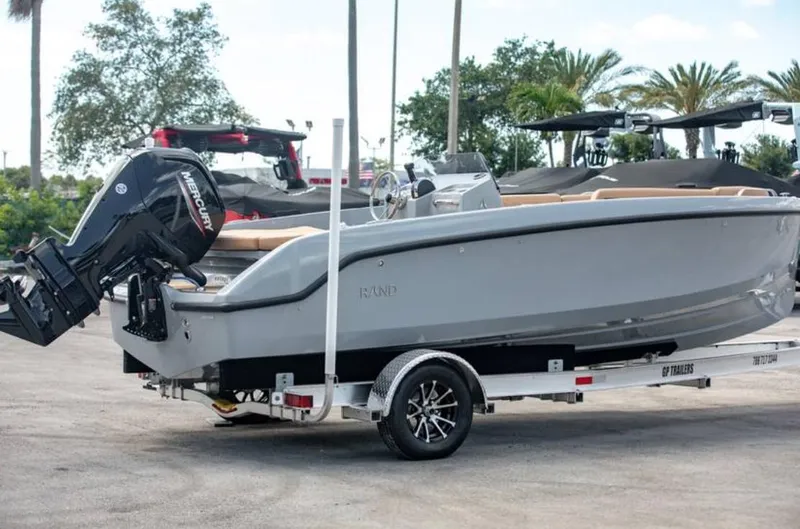 Slide: The Image of 2022 Rand BREEZE boat on a trailer with Mercury outboard motor. - 1