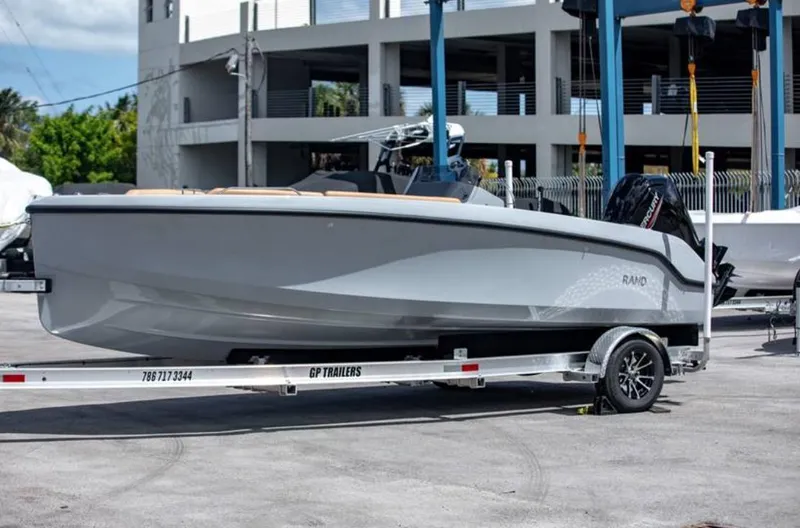 Slide: The Image of 2022 Rand BREEZE boat on a trailer in a marina. - 10