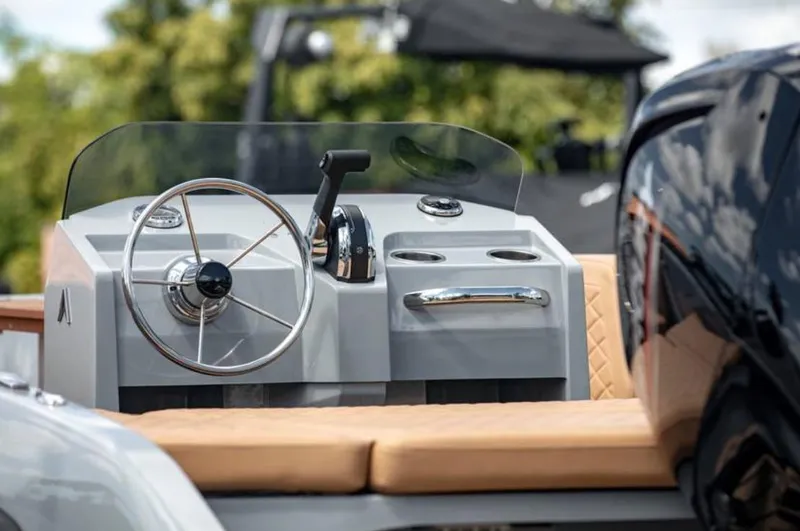 Slide: The Image of 2022 Rand BREEZE boat cockpit with steering wheel and control panel. - 14
