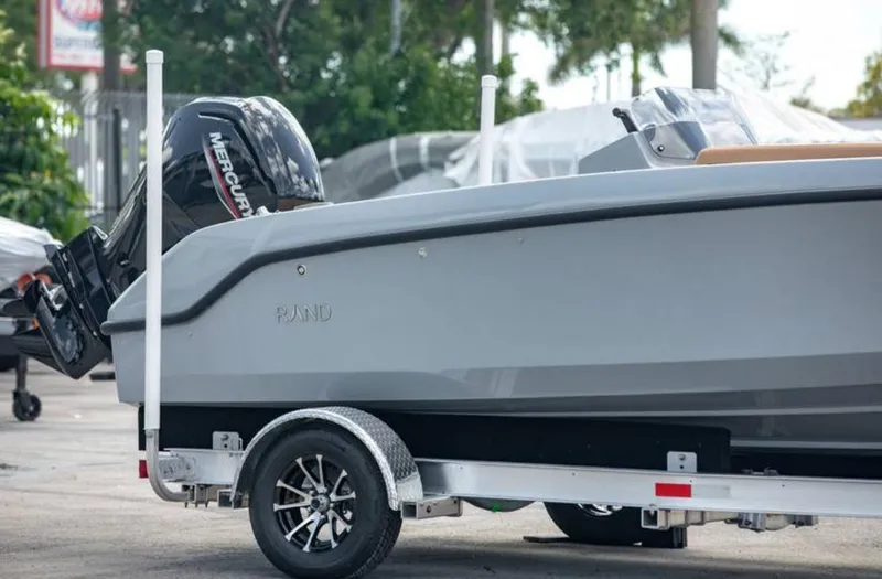 Slide: The Image of 2022 Rand BREEZE boat on trailer with Mercury outboard motor. - 2