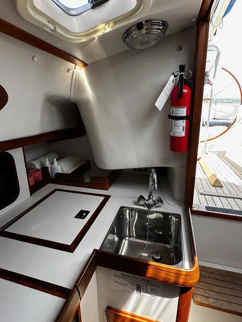 Slide: The Image of 2009 Alerion Express 38 yacht interior with sink and fire extinguisher. - 22
