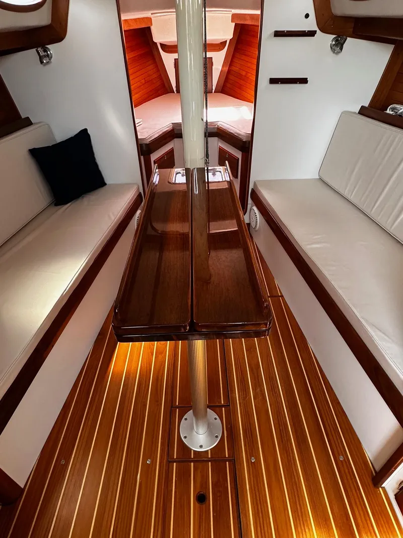 Slide: The Image of Interior of 2009 Alerion Express 38 sailboat with polished wood and white seating. - 23
