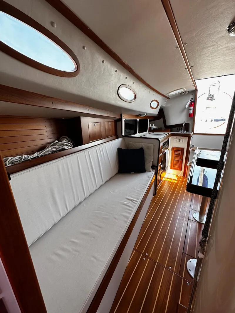 Slide: The Image of Interior of 2009 Alerion Express 38 sailboat with wooden flooring and white seating. - 26