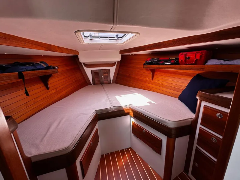 Slide: The Image of Cozy cabin interior of 2009 Alerion Express 38 sailboat with wooden accents and storage. - 27
