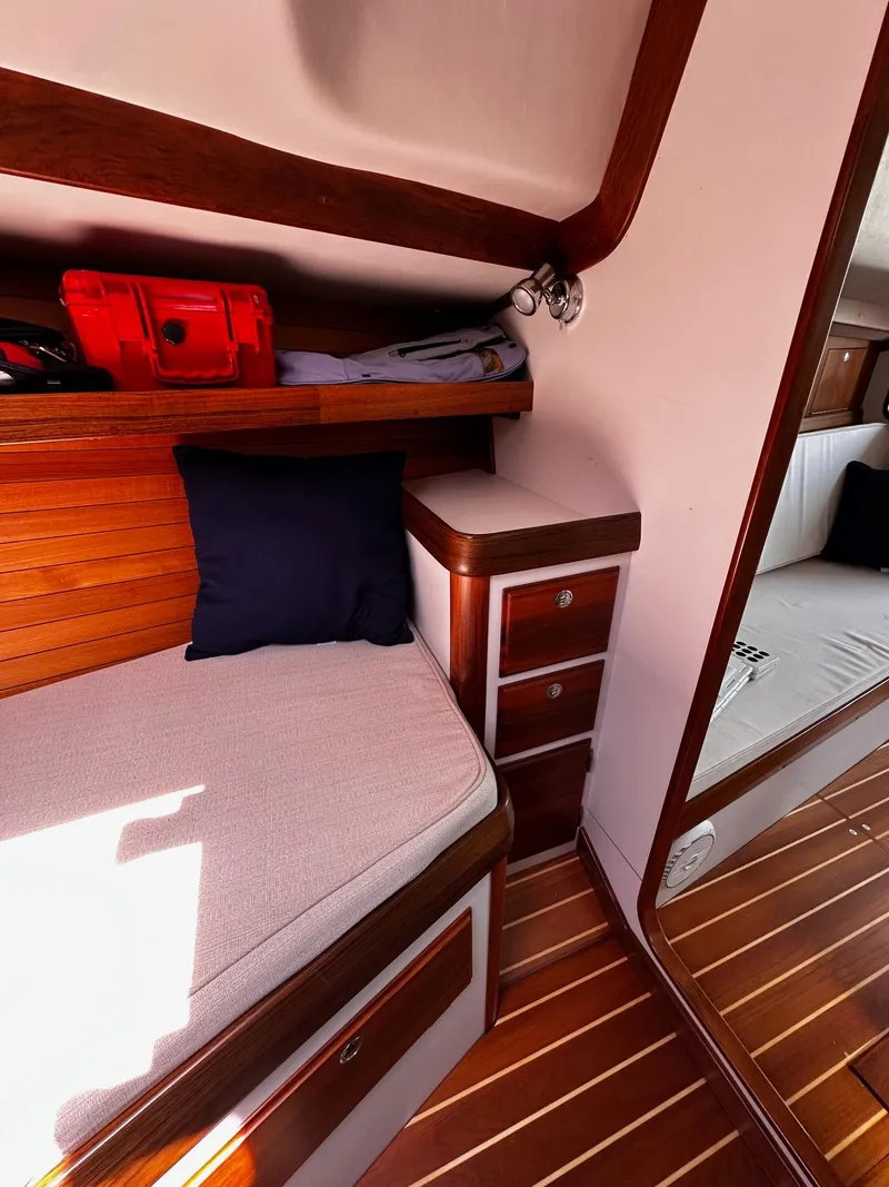 Slide: The Image of Cozy cabin interior of 2009 Alerion Express 38 sailboat with wooden accents and storage. - 28