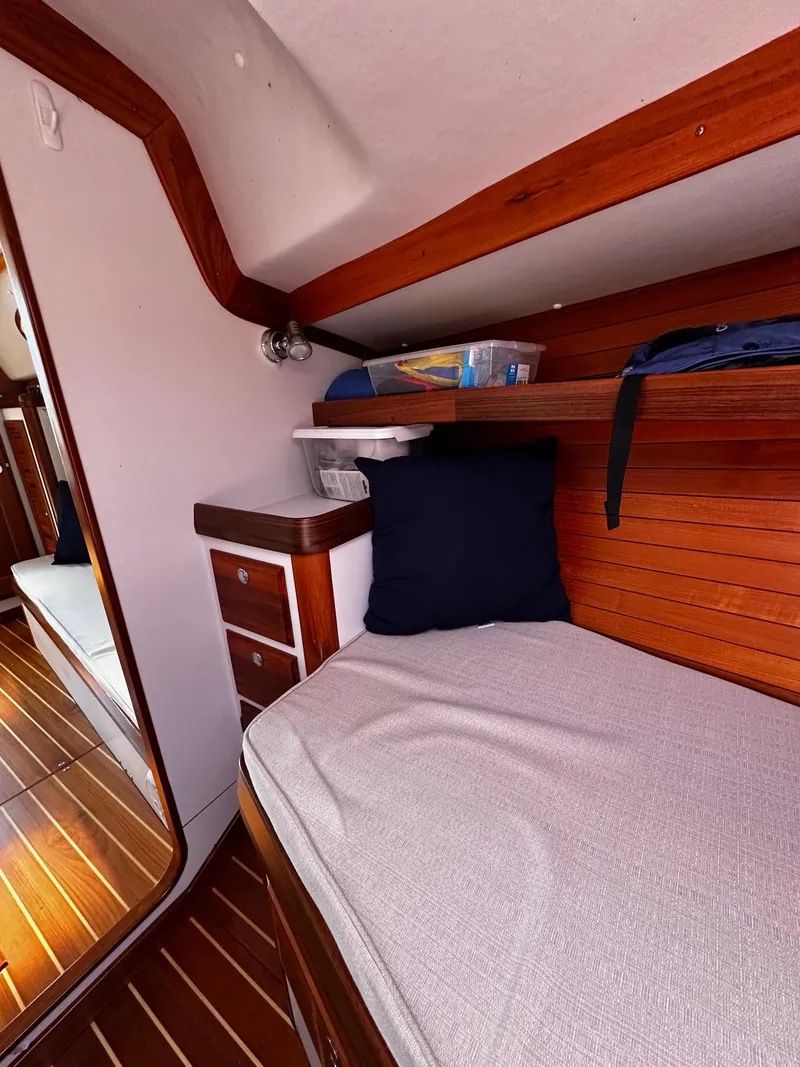 Slide: The Image of Cozy cabin interior of 2009 Alerion Express 38 sailboat with wooden accents and bedding. - 29