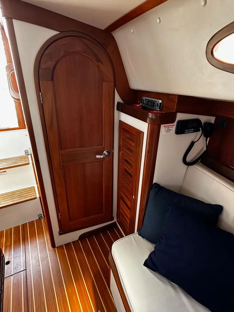 Slide: The Image of Interior of 2009 Alerion Express 38 sailboat with wooden door and seating area. - 32