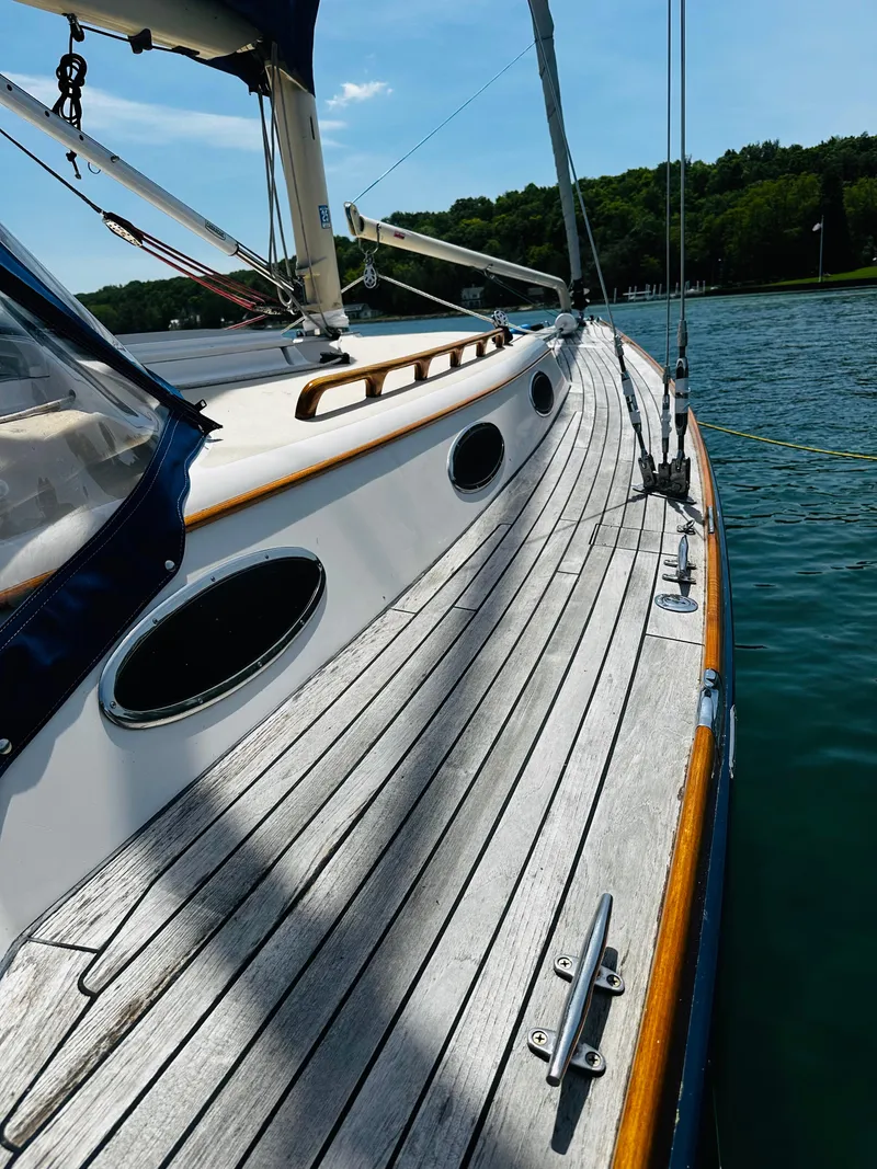 Slide: The Image of 2009 Alerion Express 38 sailboat deck with wooden finish, docked on a sunny day. - 36