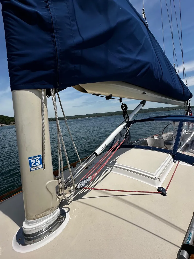 Slide: The Image of 2009 Alerion Express 38 sailboat deck with blue sail cover, on calm water. - 39
