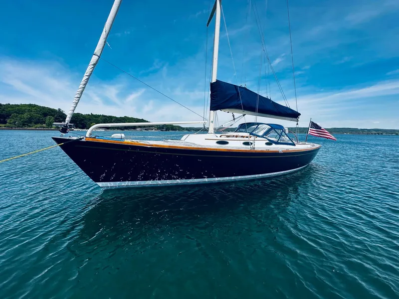 Slide: The Image of 2009 Alerion Express 38 sailboat on calm water under clear blue sky. - 7