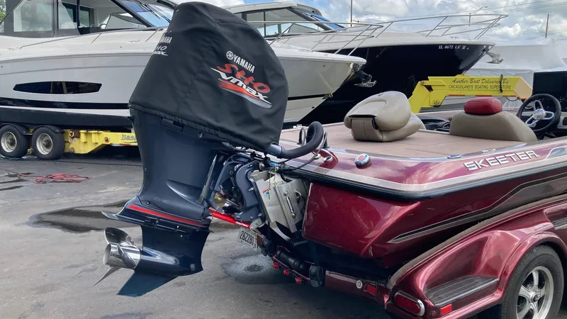 Slide: The Image of 2012 Skeeter FX 20 bass boat on trailer at marina. - 1