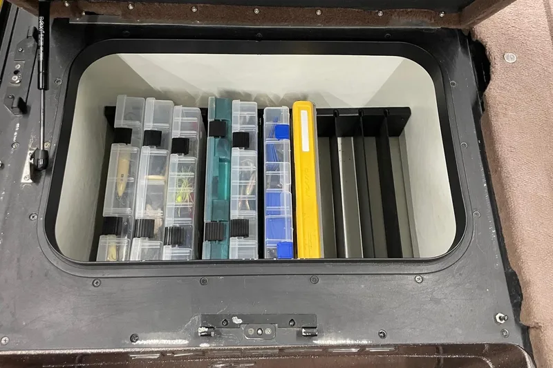 Slide: The Image of Storage compartment with organized tackle boxes in a 2012 Skeeter FX20 boat. - 14