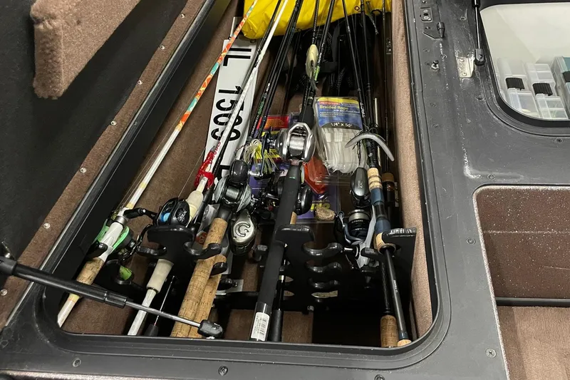 Slide: The Image of Fishing rods and gear stored in a 2012 Skeeter FX20 boat compartment. - 15
