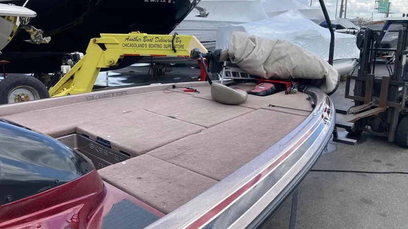 Slide: The Image of 2012 Skeeter FX20 fishing boat on calm lake with fishing rods and equipment. - 5