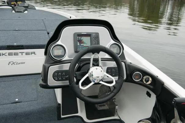Slide: The Image of 2012 Skeeter FX 20 boat interior with beige, black, and red seats. - 9