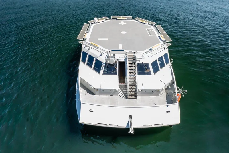 Slide: The Image of Dakota Creek 1999 catamaran with helicopter landing pad on calm water. - 10