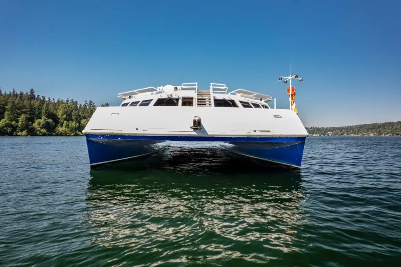 Slide: The Image of 1999 Dakota Creek Catamaran, helicopter capable, on calm water with clear blue sky. - 12