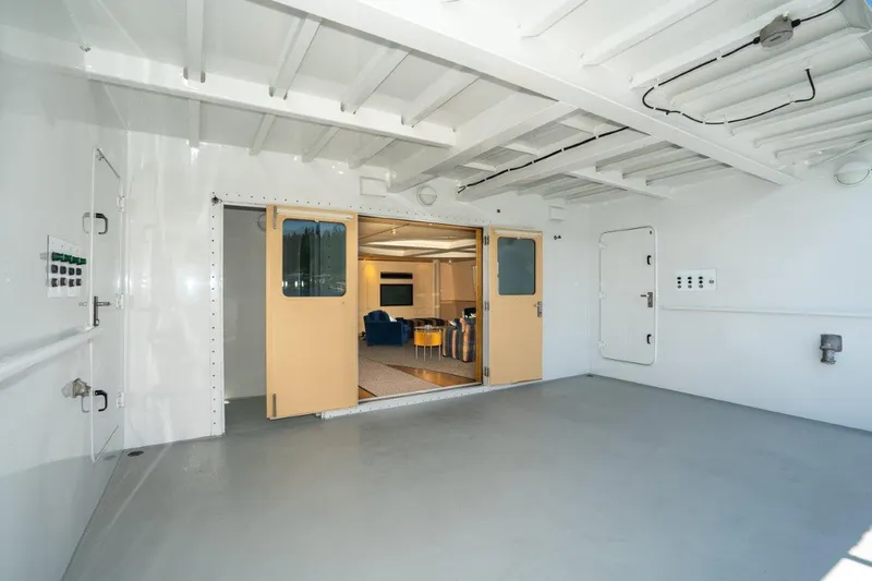 Slide: The Image of Interior of 1999 Dakota Creek Catamaran, featuring spacious helicopter-capable deck and modern lounge area. - 16