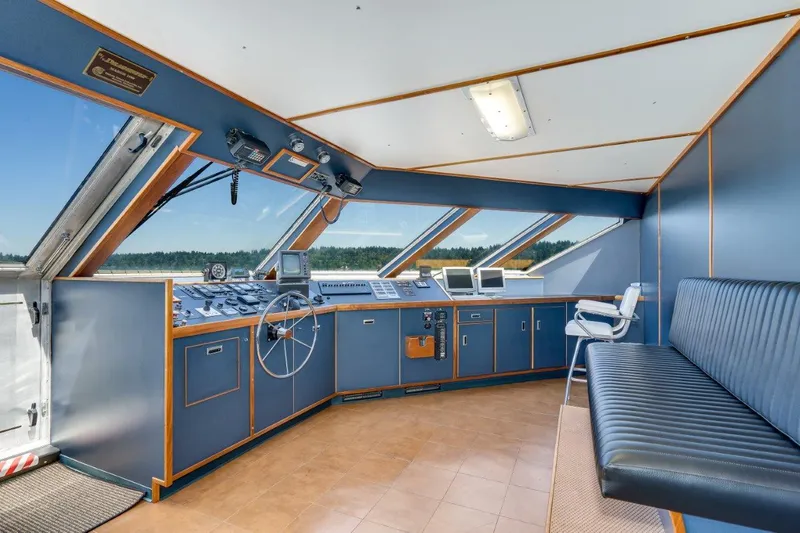Slide: The Image of Bridge interior of 1999 Dakota Creek Catamaran, featuring navigation equipment and seating. - 17
