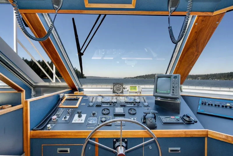 Slide: The Image of Helm of 1999 Dakota Creek Catamaran, featuring navigation controls and panoramic view. - 21