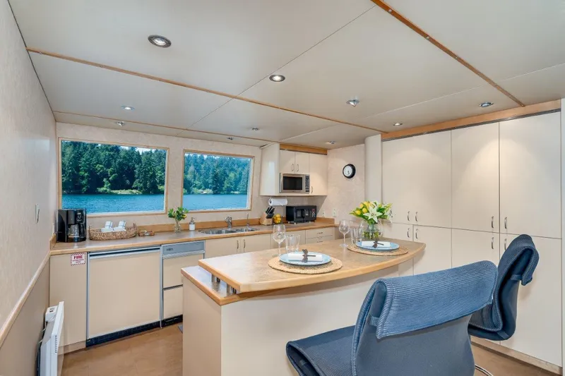Slide: The Image of Luxurious kitchen interior of 1999 Dakota Creek Catamaran with scenic window views. - 32