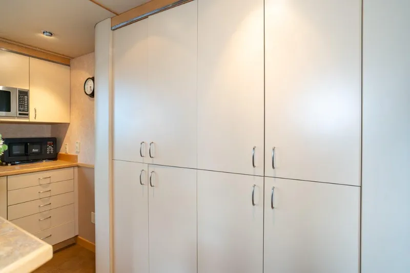 Slide: The Image of Modern kitchen interior with white cabinets and appliances on a 1999 Dakota Creek Catamaran. - 35