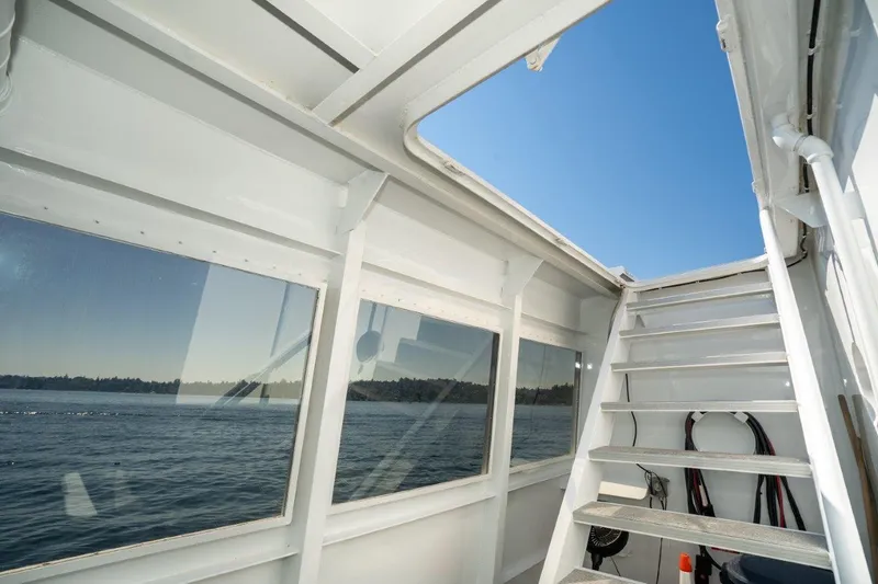 Slide: The Image of Interior view of 1999 Dakota Creek Catamaran, showcasing stairs and ocean through windows. - 41
