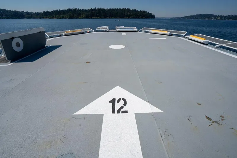 Slide: The Image of Helicopter landing pad on 1999 Dakota Creek catamaran, marked with number 12, ocean view. - 44