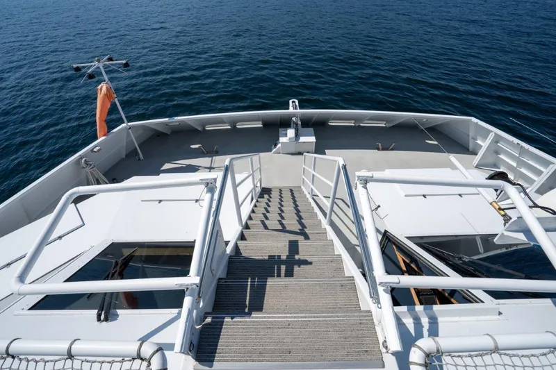 Slide: The Image of Dakota Creek 1999 catamaran deck with helicopter capability, overlooking calm ocean waters. - 48