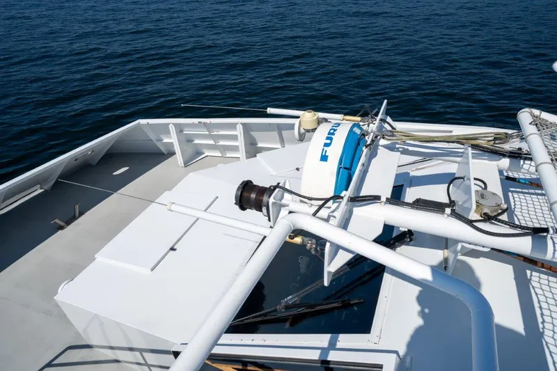 Slide: The Image of 1999 Dakota Creek Catamaran Helicopter Capable deck with equipment, overlooking calm ocean waters. - 49