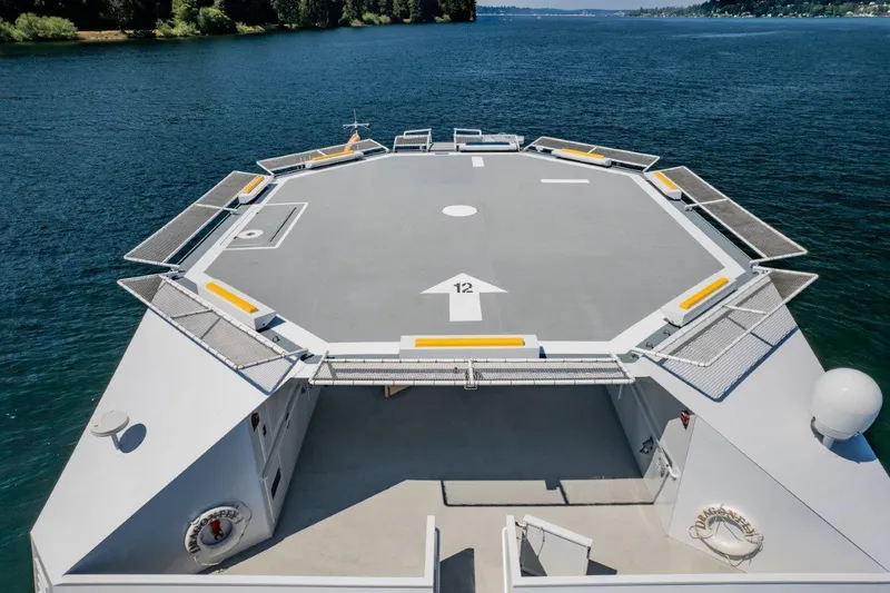 Slide: The Image of Helicopter landing pad on 1999 Dakota Creek catamaran, surrounded by water. - 5