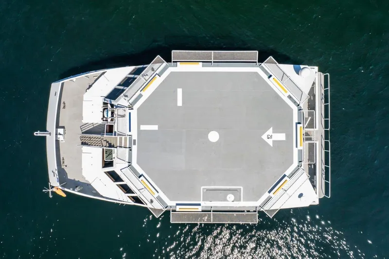 Slide: The Image of Aerial view of 1999 Dakota Creek catamaran with helicopter landing pad on water. - 6