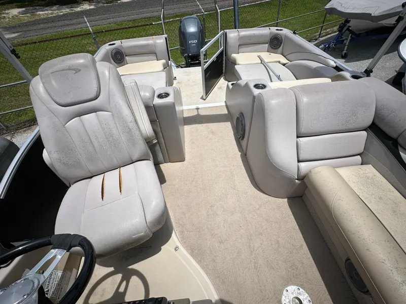 Slide: The Image of 2010 Bennington 2250RCW pontoon boat interior with beige seating and steering console. - 10