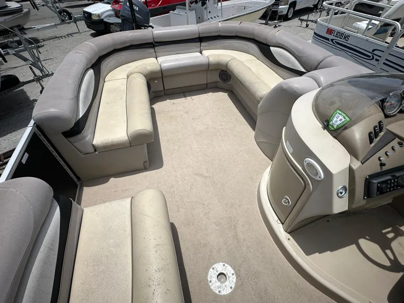 Slide: The Image of 2010 Bennington 2250RCW pontoon boat interior with beige seating and helm. - 14